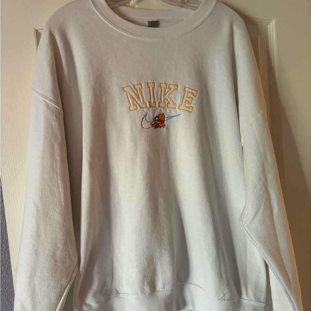 white Nike crewneck. Embroidered with Winnie the Pooh
